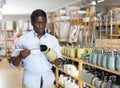 Interested african american man choosing bathroom accessories in store Royalty Free Stock Photo