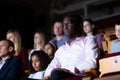 Interested african american theatergoer watching theatrical performance