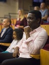 Interested african american theatergoer watching theatrical performance