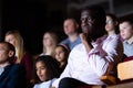 Interested african american theatergoer watching theatrical performance