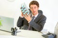 Interested businessman shaking present box Royalty Free Stock Photo