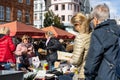 interested buyers checking the offers on a flea market