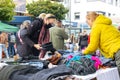 interested buyers checking the offers on a flea market