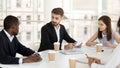 Interested colleagues listen to employee talk at company meeting