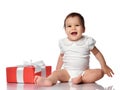 Interested curious baby in jumpsuit with gift box Royalty Free Stock Photo