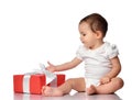 Interested curious baby in jumpsuit with gift box Royalty Free Stock Photo