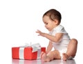 Interested curious baby in jumpsuit with gift box Royalty Free Stock Photo