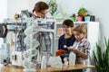 Interested kids inspecting 3d-printer placed on the working table Royalty Free Stock Photo