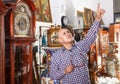 Man pointing at goods at antiques shop Royalty Free Stock Photo