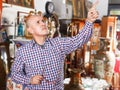 Man pointing at goods at antiques shop Royalty Free Stock Photo