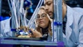 Researchers watching 3-D printing machine in process Royalty Free Stock Photo
