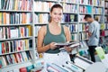 Interested teenager girl customer reading book