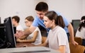 Interested teenagers studying in information technology class at library Royalty Free Stock Photo