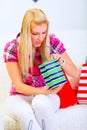 Interested woman looking in shopping bags