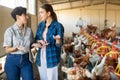 Interested women farmers taking in henhouse at poultry farm