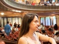 Woman waiting for start of performance in concert hall Royalty Free Stock Photo