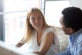 Young caucasian businesswoman manager listening to african colleague having discussion Royalty Free Stock Photo