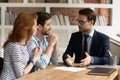 Interested young family couple visiting financial advisor in office. Royalty Free Stock Photo