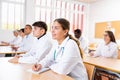 Young female student listening to lecture during professional medical training Royalty Free Stock Photo