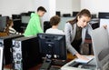 Woman copying notes on copy machine in library computer lab Royalty Free Stock Photo