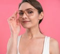 Interested young woman holding glasses looking ,well hello there, look in whats happening , or wowing, wearing Royalty Free Stock Photo