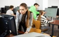 Interested young woman studying in university computer lab Royalty Free Stock Photo