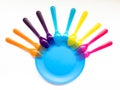 Interesting coloured plastic tableware on a white background, on Royalty Free Stock Photo