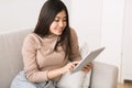 Interesting content. Asian girl reading blog on digital tablet