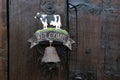 An interesting and nice doorbell on a farmhouse with a cow