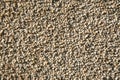 Fragment of a outdoor coating made of grey scabrous sand, closeup. Abstract grainy textured background. Royalty Free Stock Photo