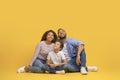 Interesting Offer. Smiling Black Family Of Three Looking Upwards At Copy Space