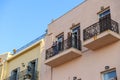 Interesting photo of old lady standing on balcony of old building.