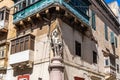 Malta, Valletta, August 2019. An ancient statue of a saint at the corner of a Maltese house.