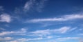 Interesting shaped wispy white clouds in blue sky Royalty Free Stock Photo