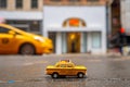 Interesting shot of an old yellow taxi toy in New York City, USA Royalty Free Stock Photo