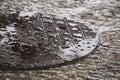 A round, flooded, manhole cover, set during a hard tropical thunderstorm in Thailand. Royalty Free Stock Photo