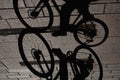 Interesting view of a man riding a bicycle and his shadow