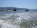 Interesting view of rocks at bay of ACAPULCO city in Mexico with Pacific Ocean waves on sandy beach landscape Royalty Free Stock Photo