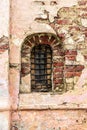 An arched window in the wall of an old church. Royalty Free Stock Photo