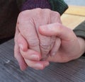 Intergenerational hands, teenage girl and elderly grandmother holding hands, in close up