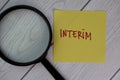 Interim write on sticky notes isolated on Wooden Table