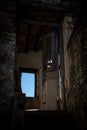 Interior of an abandoned deserted room. Bright light from the open window and door. Abandoned places Royalty Free Stock Photo