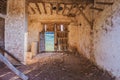 Interior of abandoned and dilapidated house with broken wooden door