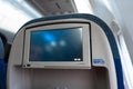 The interior of the aircraft. Empty airplane cabin. Rows of passenger seats with screens in the head restraints