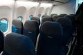 The interior of the aircraft. Empty airplane cabin. Rows of passenger seats with screens in the head restraints Royalty Free Stock Photo