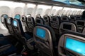 The interior of the aircraft. Empty airplane cabin. Rows of passenger seats with screens in the head restraints Royalty Free Stock Photo