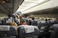 Interior of airmoldova airplane with passengers on seats and stewardess walking the aisle