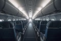 Interior of an airplane cabin with comfortable seats, overhead compartments