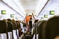 Interior of airplane with passengers on seats.