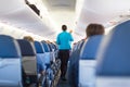 Interior of airplane with passengers on seats.